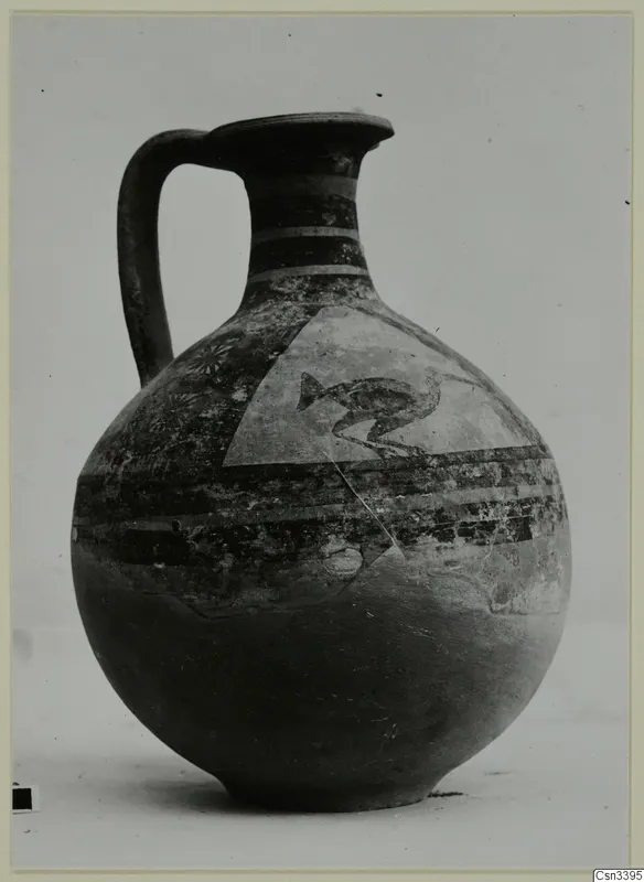 Painted jug with a single handle, banded neck and a triangular panel on the shoulder with a dark bird-like motif