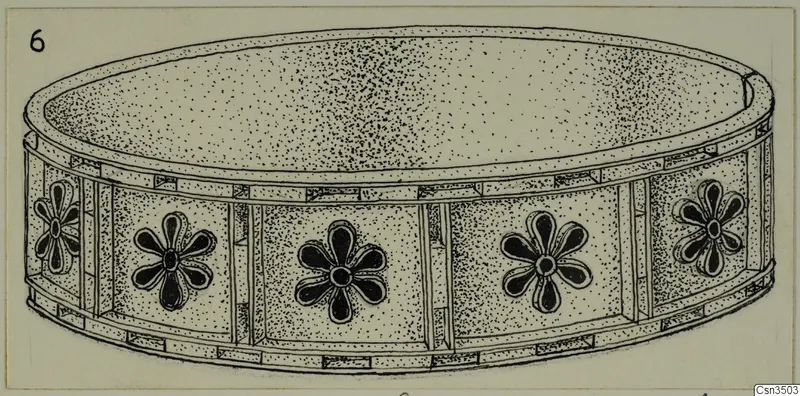 Field drawing of a shallow gold object with flower-like rosettes around its side