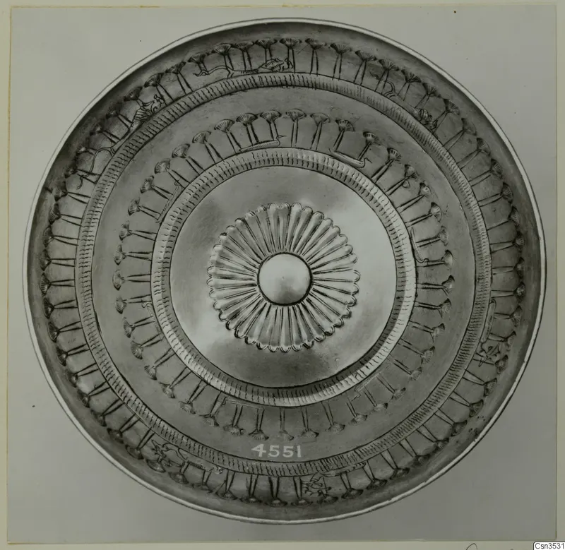 Metal dish seen from above, with a central rosette and concentric bands of embossed ornament and small figures