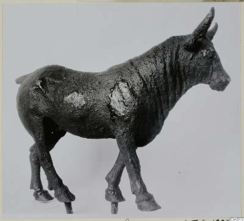 Bronze figure of a standing horned animal in side view