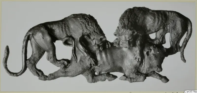 Bronze relief of two lions attacking a bull, shown against a pale background.