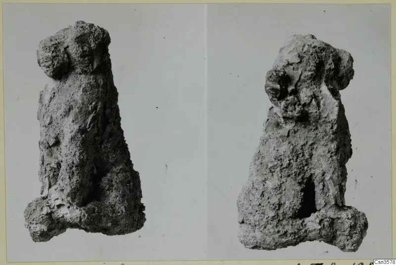 Two views of a heavily corroded metal figure with a head at top and a tapering body, on a mounted photograph card.