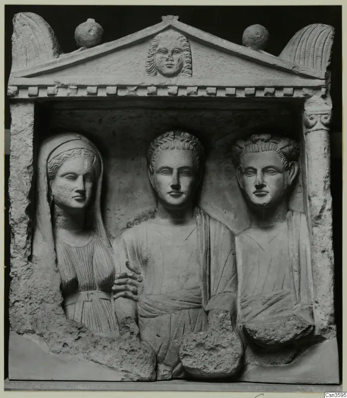 Limestone relief of three busts in a pedimented niche, with a veiled woman on the left and two men beside her.