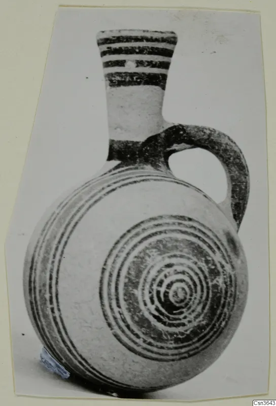 Pottery Bichrome II jug with banded neck, loop handle and concentric circles on the body