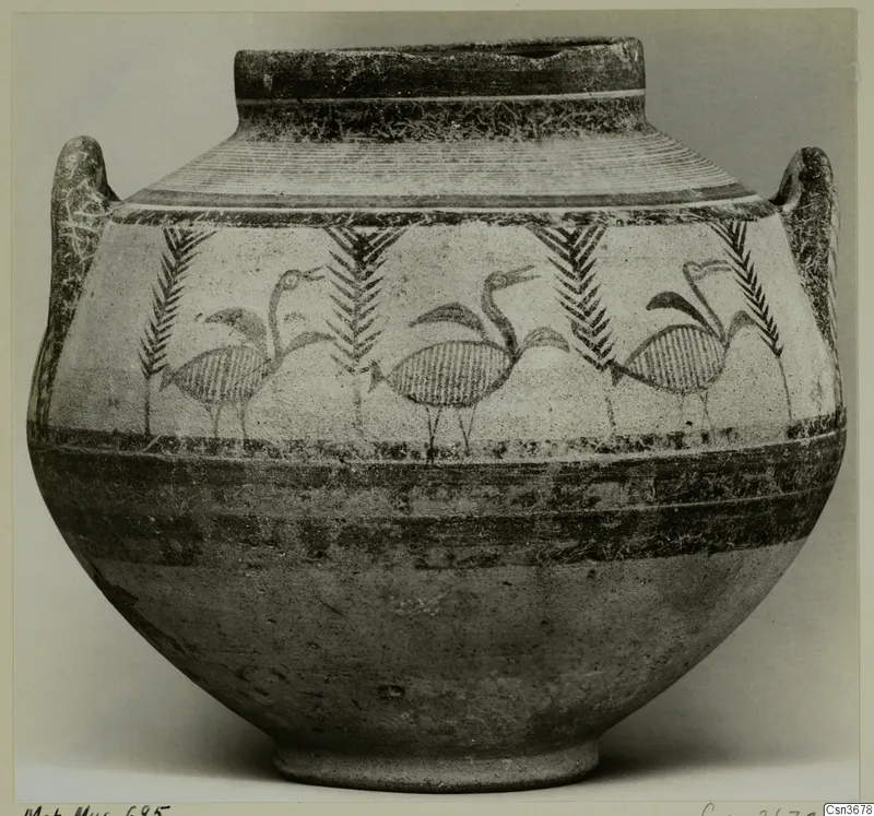 Bichrome IV jug with two handles, painted with long-necked birds between palm-like motifs and horizontal bands.