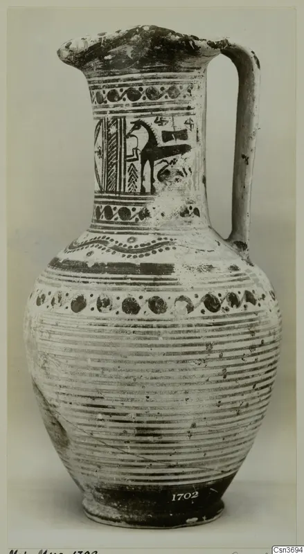 Jug with a flaring mouth and strap handle, painted with dark bands and a horse-like animal on the neck.