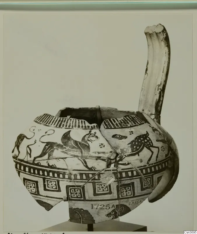 Reconstructed painted pottery vessel with a tall curved spout, decorated with animal friezes and geometric panels.