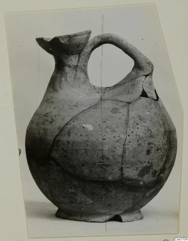 Jug with a round body, strap handle and broken flaring mouth, from Marion tombs 31–45