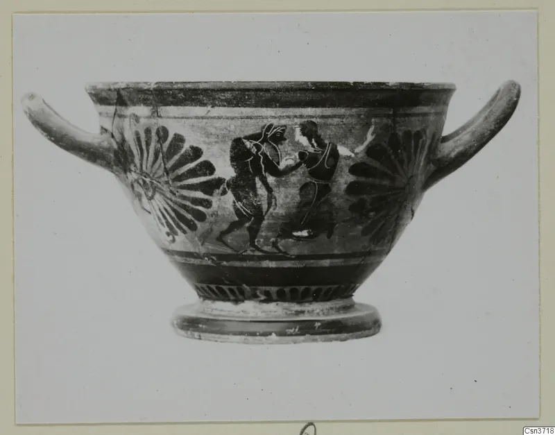 Black-figure two-handled bowl with two figures in silhouette between fan-shaped motifs on its side
