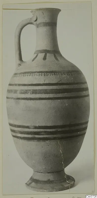 Pottery jug with dark painted bands and a single handle, from Vouni.