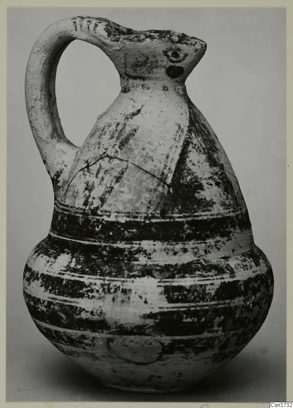 Bichrome V jug with a single handle and dark painted bands around its body