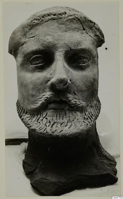 Sculpted bearded head from Mersinaki, shown frontally, with the neck broken off