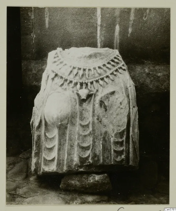 Stone statue fragment from Arsos, carved with a collar of pendant drops and curved relief bands