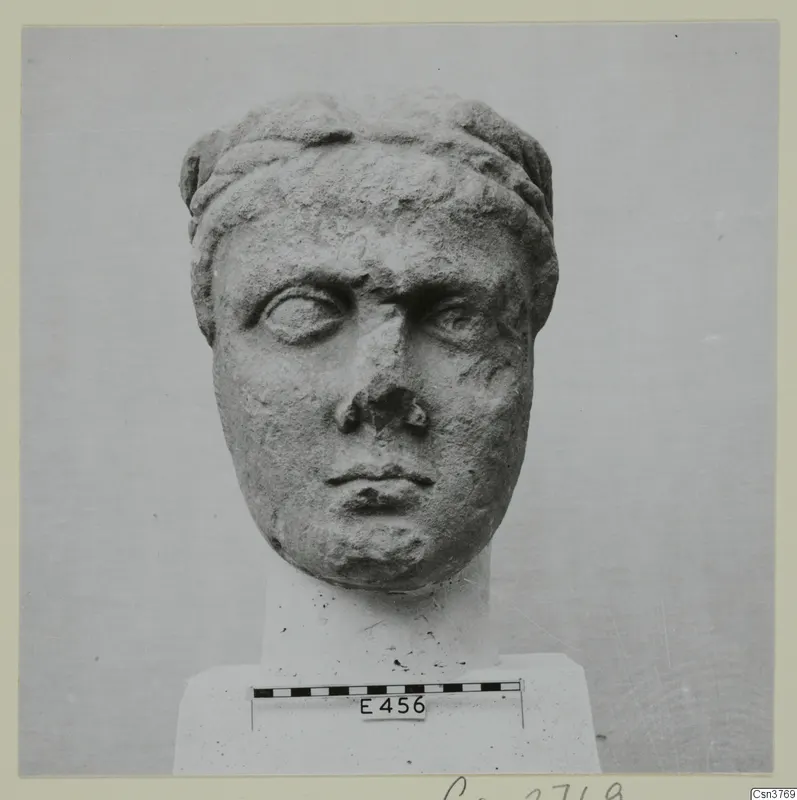Roman stone head on a block base, with a scale bar and a number label placed in front