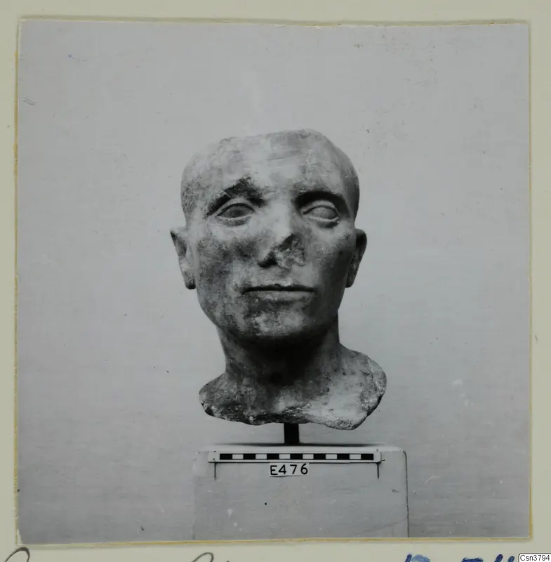 Roman sculpture of a man's head on a stand, with a damaged nose