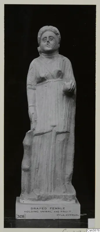 Standing stone statue of a draped female figure, shown front-on against a dark background