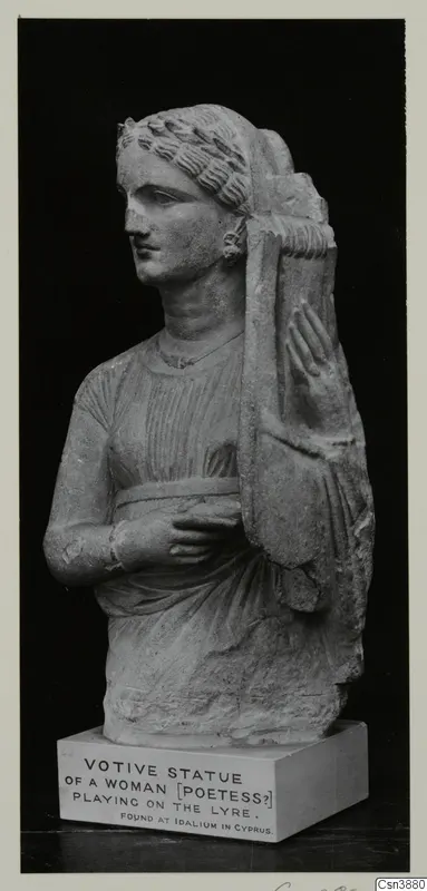 Stone statue of a woman with a lyre, photographed against a black background on a plinth with a printed label.