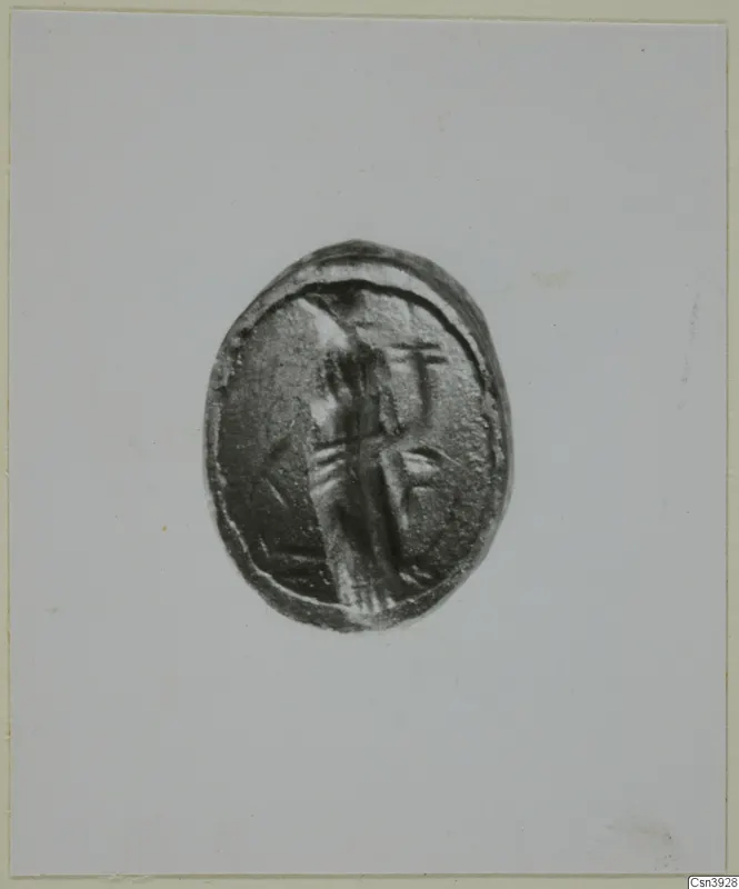 Oval engraved seal or gem showing a standing figure, photographed face-on