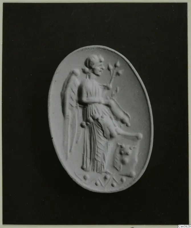 Oval relief of a winged figure holding a branch, pale against a dark backdrop.