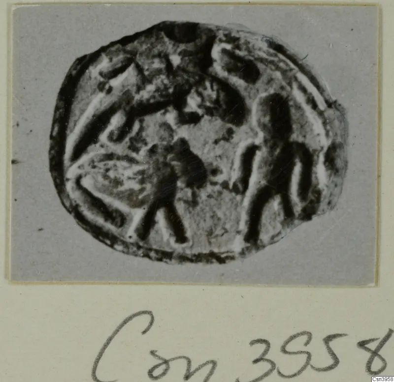 Oval seal or gem with carved figures, shown in a photograph mounted on a grey card