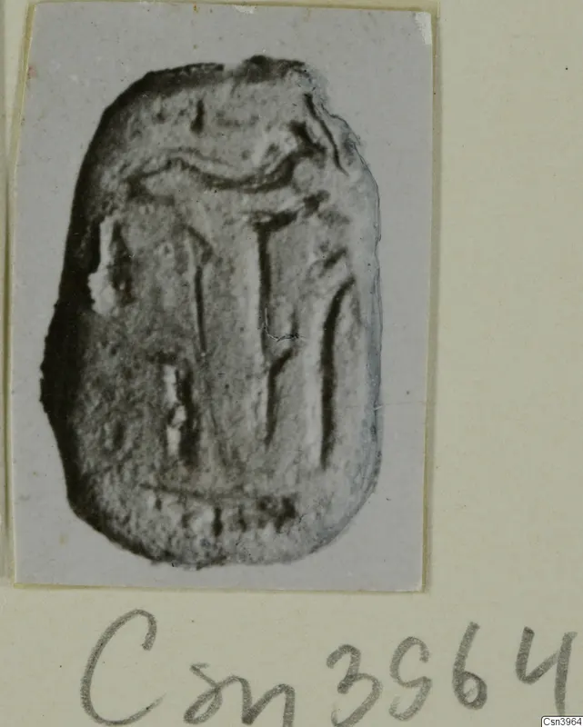 Small oval seal or gem with incised linear design, photographed on a mounted card