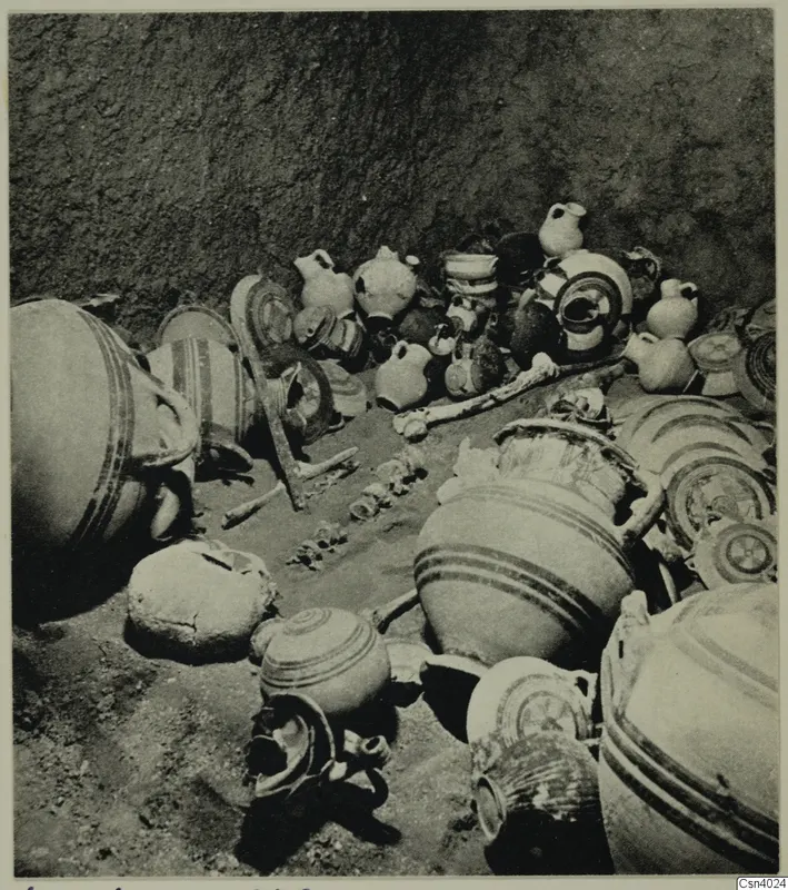 Pottery vessels and bone fragments lying together on the floor of a pit, Lapithos