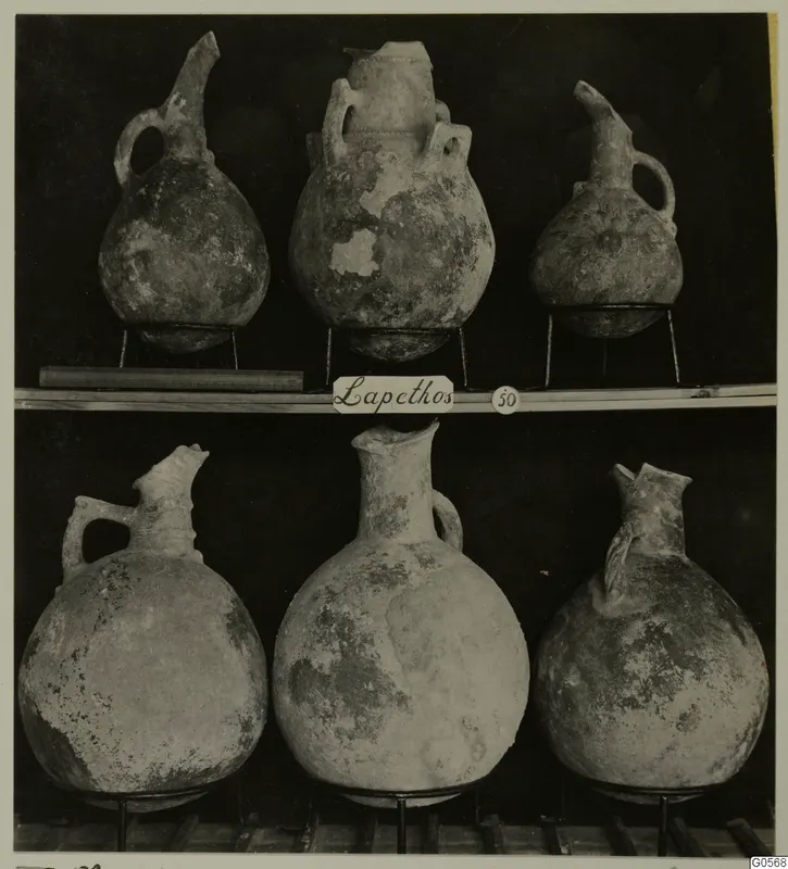Pottery jugs in two rows on metal stands, from Lapithos Markides T.50