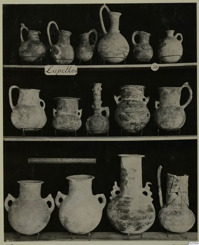 Pottery jugs, jars and flasks on three shelves, with a place label and number 50, from Lapithos Markides Tomb 50