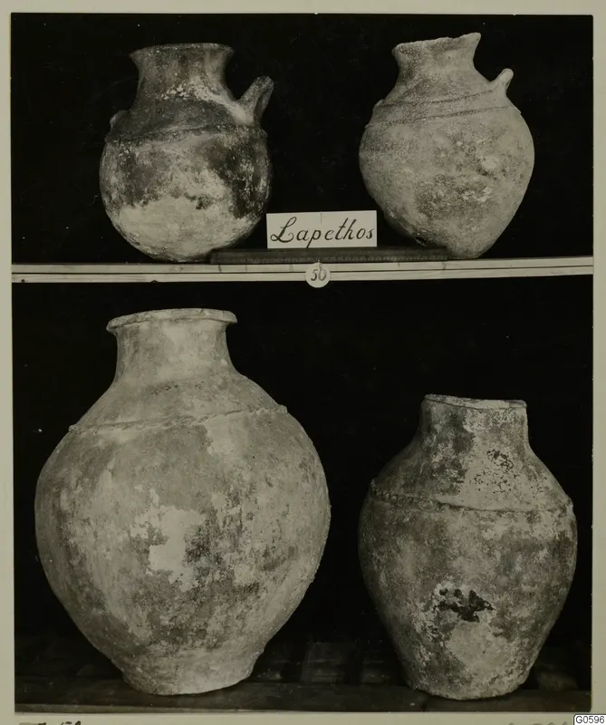 Four pottery vessels from Lapithos Markides Tomb 50 on two shelves, two small jugs above and two large jars below.