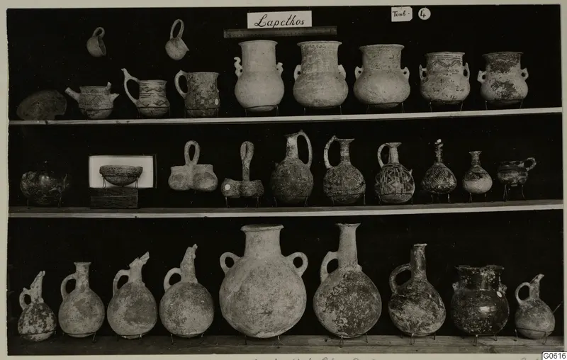 Pottery jugs, juglets and bowls from Lapithos Markides, T.4, displayed on three shelves.