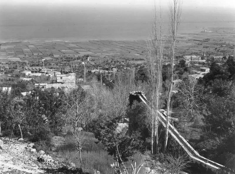 View over Lapithos, with village buildings, cultivated fields on the coastal plain and the sea beyond