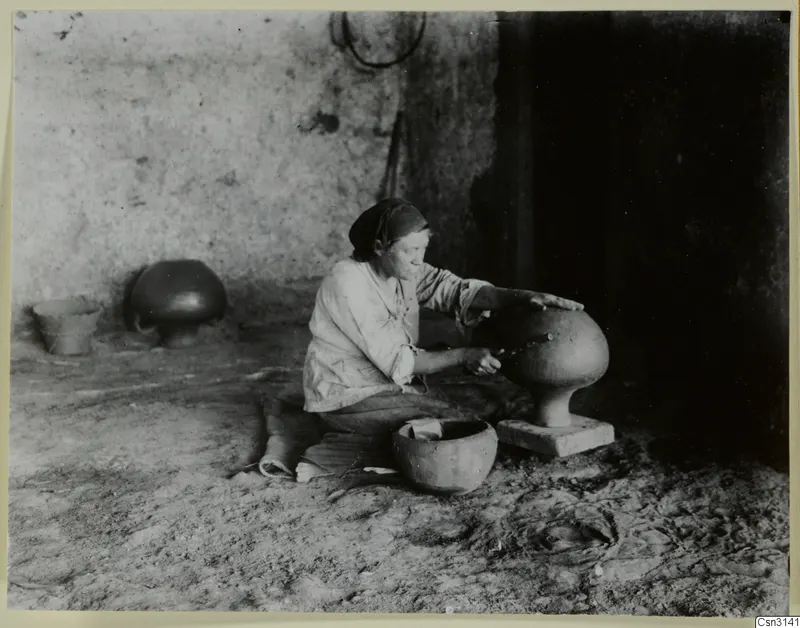 Woman polishing a large clay vessel on a pedestal at Klirou village