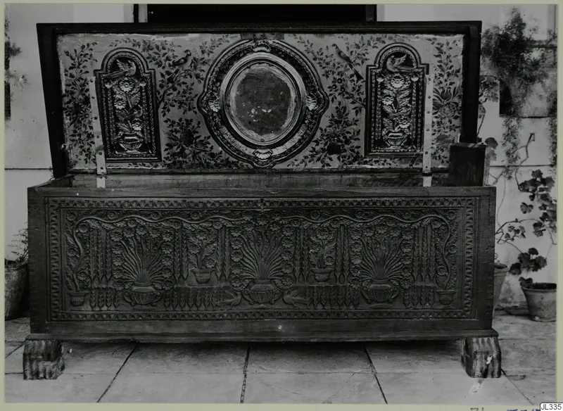 Carved wooden clothes chest, called sendudzin, with its lid open to show a painted inner lid