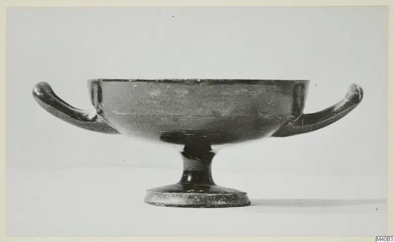 Two-handled footed bowl of black-glazed ware, photographed in side view