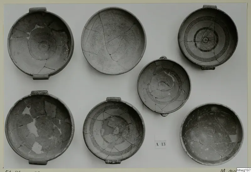 Seven handled bowls from Amathus, several with concentric painted bands, photographed from above.