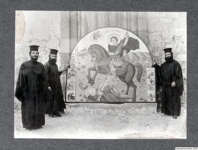 Three bearded men in black robes and tall black hats stand before a painted arched icon of a haloed rider spearing a fallen armoured knight.
