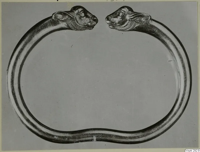 Heavy metal ring with two animal heads facing each other across the gap, from Vouni