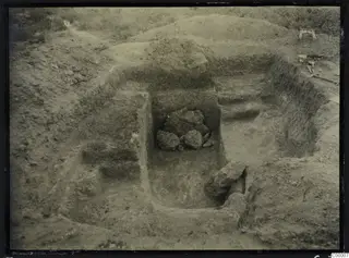 Excavated dromos of Tomb 303 at Vrysi tou Barba, Lapithos, with stones in the cut and tools at the edge