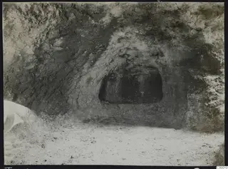 Rock-cut tomb chamber opening in a sandy cutting at Vrysi tou Barba, Lapithos, during excavation