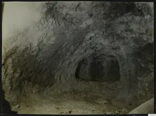 Tomb 302 at Vrysi tou Barba, Lapithos, during excavation, showing the opening of a tomb chamber in a rough earthen wall.