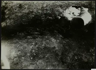 Tomb 313 b at Vrysi tou Barba, Lapithos: interior of a tomb chamber with dark vessels, during excavation
