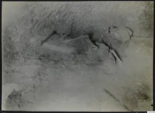 Tomb 305 at Lapithos, Vrysi tou Barba: skeletal remains lying in soil on the floor of a tomb chamber during excavation