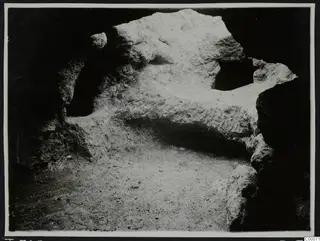 Tomb 306 at Lapithos, Vrysi tou Barba, during excavation: pale rock inside the tomb chamber above a sandy floor.