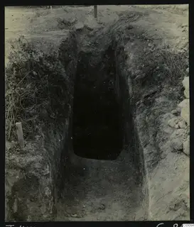 Tomb 414 at Lapithos during excavation, a steep cut passage leading down to a dark tomb chamber opening