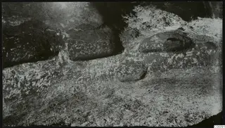 Rock-cut tomb chamber at Vrysi tou Barba, Lapithos, with rounded hollows in the floor during excavation