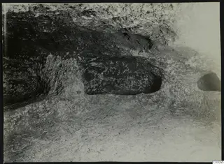 Interior of tomb chamber at Vrysi tou Barba, Lapithos, with rock-cut hollows in the walls during excavation