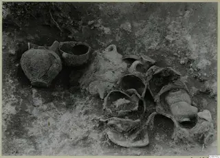 Tomb 404 at Lapithos Kastros: pottery vessels lying in situ in excavated soil