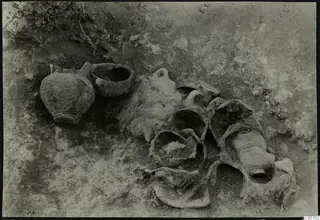 Vessels lying in soil during excavation of Tomb 404 at Lapithos Kastros