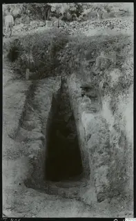 Dromos leading down to the entrance of Tomb 406 at Lapithos, with a drystone wall above.