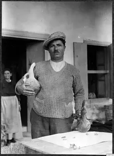 Man in a cap holding two pottery vessels, one large and pale and one small and dark, with a woman in a doorway behind him.